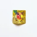 d8, Yellow with red metallic flakes, pink and blue bleed